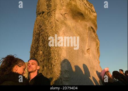 Watching and feeling the sun rise during the Summer Solstice at Stonehenge. Stock Photo