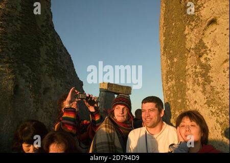 Watching and feeling the sun rise during the Summer Solstice at Stonehenge. Stock Photo