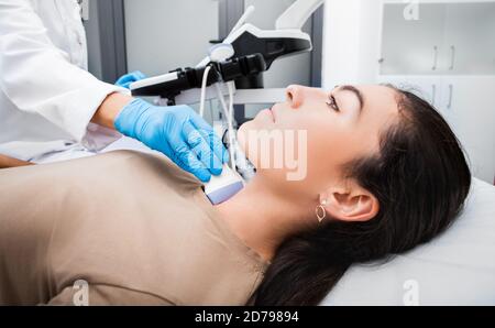 Female patient receives thyroid diagnostics. Treatment of thyrotoxicosis, and hypothyroidism Stock Photo