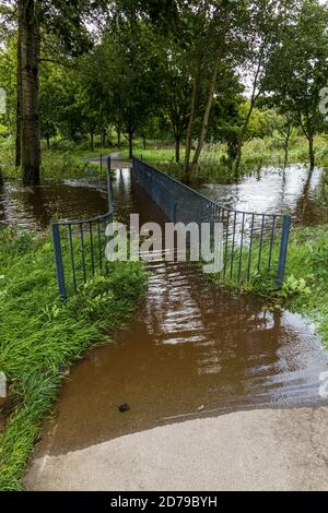 Blackwater river flooding over a footbridge in the park, grounds at the castle in Mallow, County Cork, Ireland Stock Photo