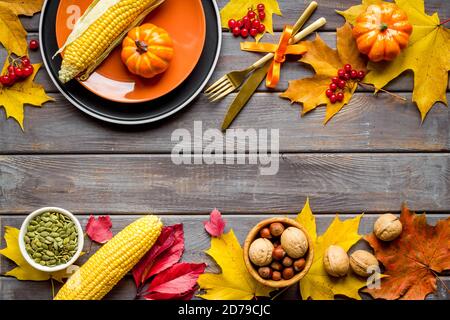 Thanksgiving day dinner table, top view . Autumn vegetables on plate with cutlery Stock Photo