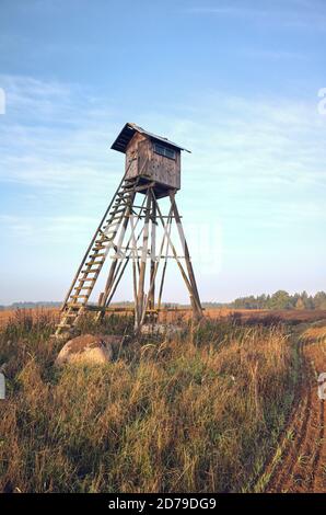 Elevated wooden hunting blind on a field in early morning. Stock Photo