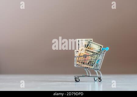 shopping cart full of dollar bills , business, finance, economy concept Stock Photo