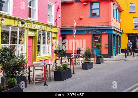 Brightly painted colourful facade and outside eating area on the street, initiative by council to help business during covid in Kinsale, County Cork, Stock Photo