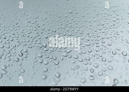 rain drops on a grey window during a thunder storm Stock Photo