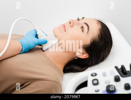 Female patient receives thyroid diagnostics. Treatment of thyrotoxicosis, and hypothyroidism Stock Photo
