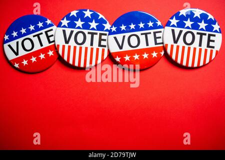 Vote buttons on red background with copy space. Election theme Stock Photo