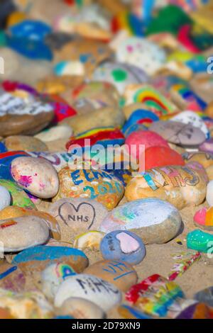 Hand Painted Colourful Pebbles Celebrating The NHS On Avon Beach Christchurch UK Stock Photo