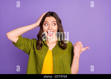 Portrait of crazy astonished girl impressed indicate incredible ads promotion discount point thumb finger touch head hands scream wear good look Stock Photo