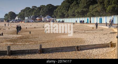 View Of Avon Beach Christchurch UK Along A Row Of Beach Huts Towards Mudeford Quay Stock Photo