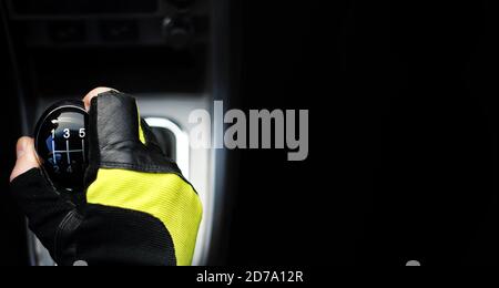 Gear lever. Manual Transmission. Hand on the gear shift in the car. Stock Photo