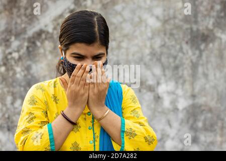health problem and people concept - unhealthy indian woman coughing with nose mask on Stock Photo