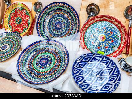 Ethnic Uzbek ceramic round plates with traditional Uzbek ornaments. Decorative ceramic plates with patterns