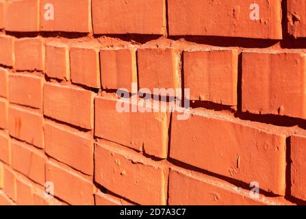 Old weathered red brick wall as background. Bricks masonry with seams. View from the angle Stock Photo