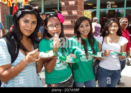 Hispanic students socialize outside at Achieve Early College High School on the campus of South Texas College. The school, part of the highly regarded McAllen school district along the Texas-Mexico border, enrolls nearly 500 students, almost 3/4 of whom come from economically disadvantaged families. Stock Photo