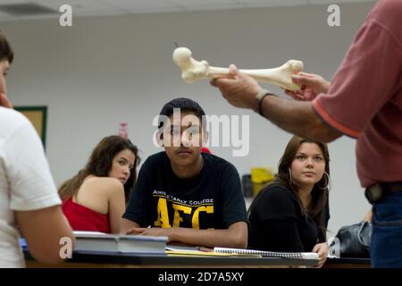 Hispanic teacher prepares students for lab in biology class at Achieve Early College High School on the campus of South Texas College. The school, part of the highly regarded McAllen school district in South Texas on the US-Mexico border, enrolls nearly 500 students, almost 3/4 of whom come from economically disadvantaged families. Stock Photo
