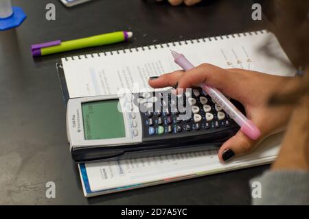 Student uses calculator during class at Achieve Early College High School on the campus of South Texas College. The school, part of the highly regarded McAllen school district in South Texas on the US-Mexico border, enrolls nearly 500 students, almost 3/4 of whom come from economically disadvantaged families. Stock Photo