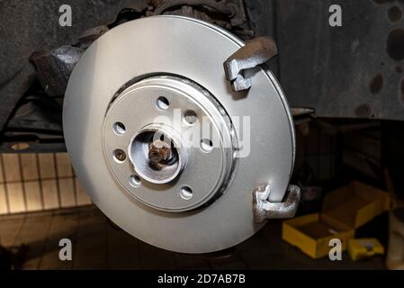 New brake disc with an anti-corrosion layer, mounted on the front hub. Stock Photo