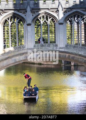 Punting under the Bridge of Sighs in Cambridge, England,  a covered bridge at St John's College, Cambridge University. Stock Photo