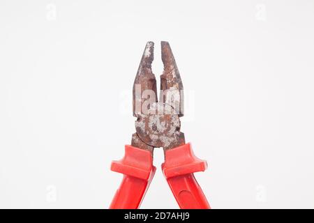 Open rusty red pliers against white background Stock Photo