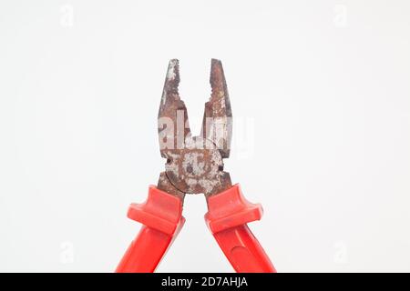 Wide open rusty red pliers against white background Stock Photo