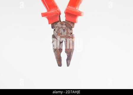 Top view of open rusty red pliers against white background Stock Photo