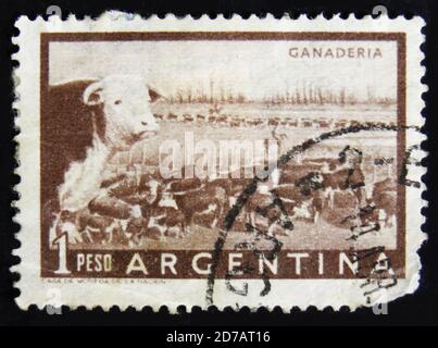 MOSCOW, RUSSIA - APRIL 2, 2017: A post stamp printed in Argentina shows a heard of beef cattle in the Argentinean walking through a gate in a fence, c Stock Photo