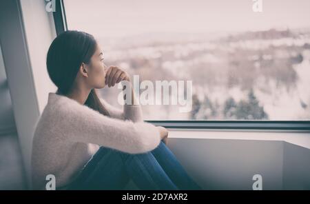 Depression, mental health, psychology therapy - mind wellness well being Asian girl with winter blues seasonal affective disorder feeling sad or heart Stock Photo