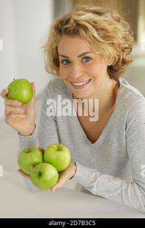 woman holding apples in her hands Stock Photo
