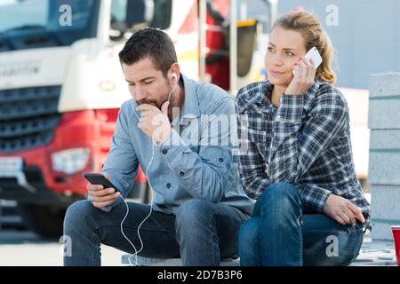 workers listening to music outdoors Stock Photo