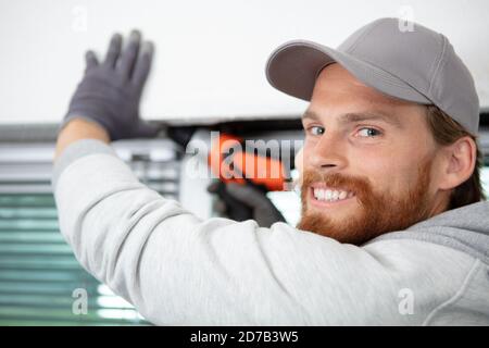 contractor using cordless screwdriver on lintel Stock Photo