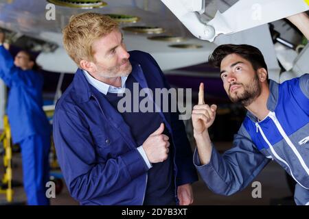 an airport worker checking chassis Stock Photo