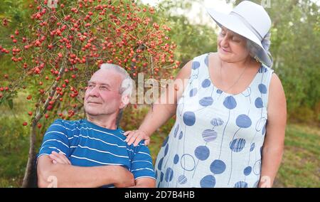 Happy senior couple enjoying each other in the park. Support and care from a loved one, warm emotions Stock Photo