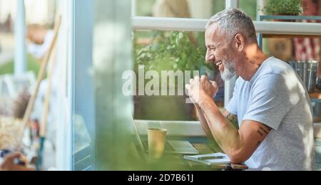 Middle aged caucasian businessman working on terrace Stock Photo