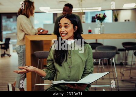 Business woman teaching colleagues tips on presentation to intrigue boss with new ideas for company before meeting Stock Photo