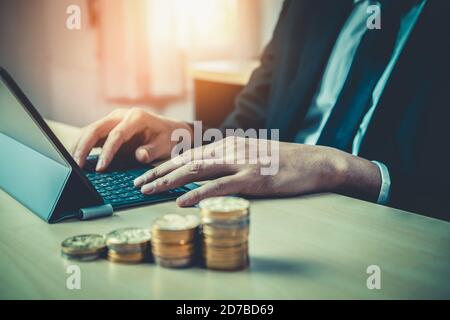 Businessman working with coin money currency. Concept of investment growth and money saving. Stock Photo