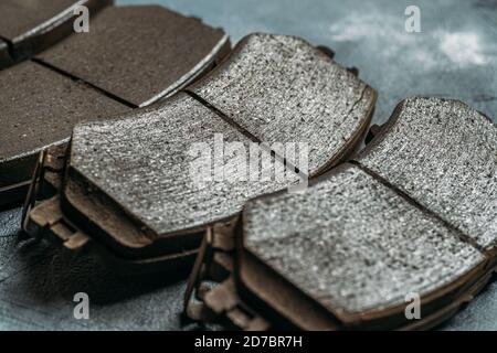 Used worn out car brake pads need to change, close up. Stock Photo