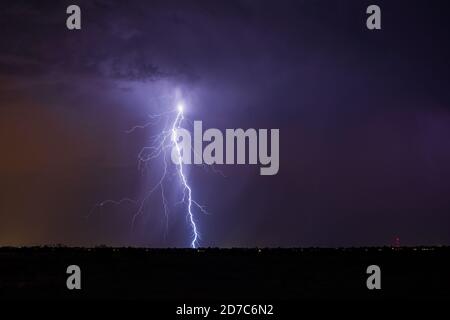 Dramatic thunderstorm lightning bolt strike from a storm in the night sky over Phoenix, Arizona Stock Photo