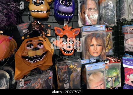 New York City, USA. 21st Oct, 2020. A paper mask of First Lady Melania Trump (center-right) on display and for sale with other Halloween masks and attires at the Halloween Adventure Halloween costume shop in New York, NY, October 21, 2020. (Anthony Behar/Sipa USA) Credit: Sipa USA/Alamy Live News Stock Photo
