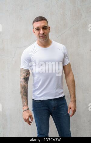 Portrait of handsome man with tattoos looking at camera Stock Photo