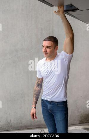 Portrait of handsome man with tattoos thinking Stock Photo