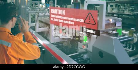 iot smart industry 4.0 concept. Industrial engineer using smart glasses with augmented mixed virtual reality technology to see the detail of part whic Stock Photo