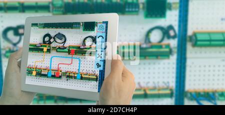 iot smart industry 4.0 concept. Industrial engineer(blurred) using smart glasses with augmented mixed virtual reality technology to read the data that Stock Photo
