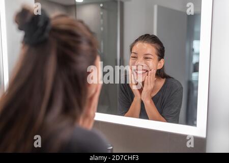 Face wash young Asian woman washing using facial scrub exfoliating skin cleansing of dead cells and oil for black pores clear skincare treatment Stock Photo