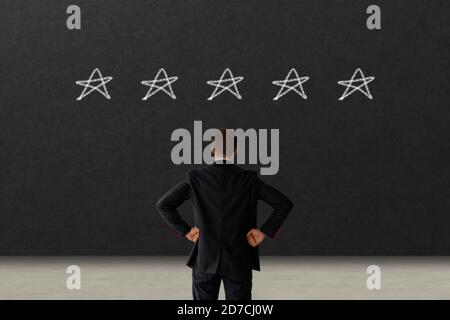 business man looking on black board excellent rating voting by customer experience with hand putting highest rate five star. best services concept. co Stock Photo