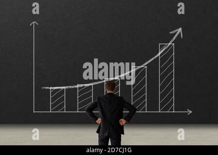 Business growth concept. business man looking to the graph with growth performance and keep goal for success Stock Photo