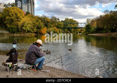London Ontairo Canada - Man Fishing in front of King St Bridge. October 2020. Luke Durda/Alamy Stock Photo