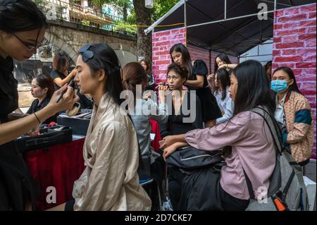 Young women getting made up for a modeling event, Pho Bich Hoa Phung Hung, Hanoi, Vietnam Stock Photo