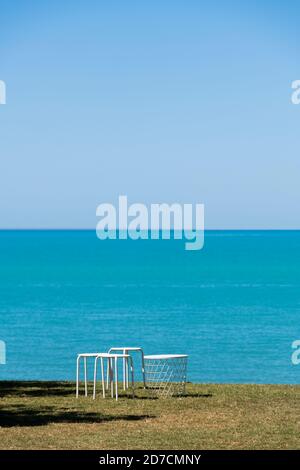 Table and stools on grass above Town Beach. Stock Photo