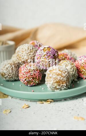energy balls, whole oat flakes and coconut powder, low-calorie sweets, on a light background Stock Photo